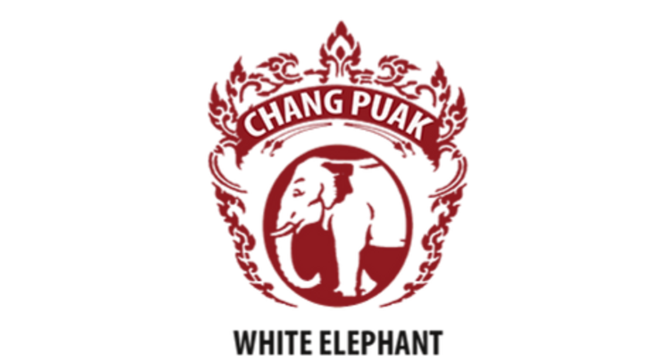 The Chang Puak crest: a crimson shield of kranok flame with an elephant in a roundel, lettered CHANG PUAK above and WHITE ELEPHANT below.